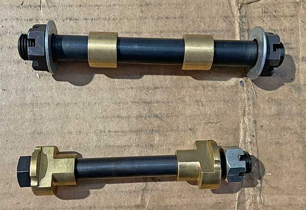 bolts, spacers, slides and nuts on the bench